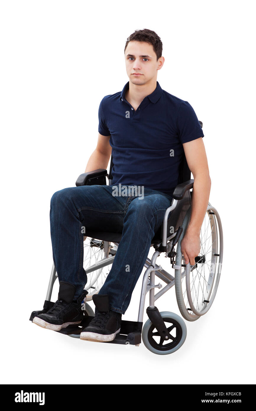 Full length portrait of confident young man sitting in wheelchair isolated over white background Stock Photo