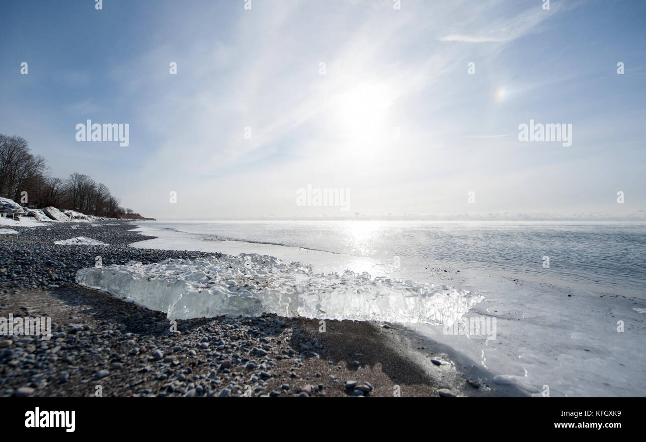Landscape view of large ice chunk on icy beach along Lake Ontario after the December 2013 ice storm during polar vortex of 2014 in Whitby, ON, Canada Stock Photo