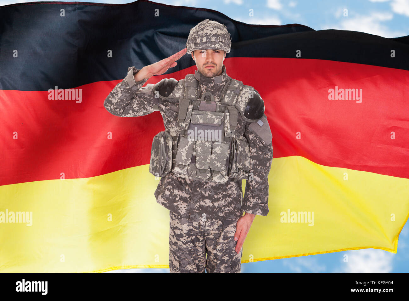 Portrait Of German Soldier Saluting In Front Of Flag Stock Photo