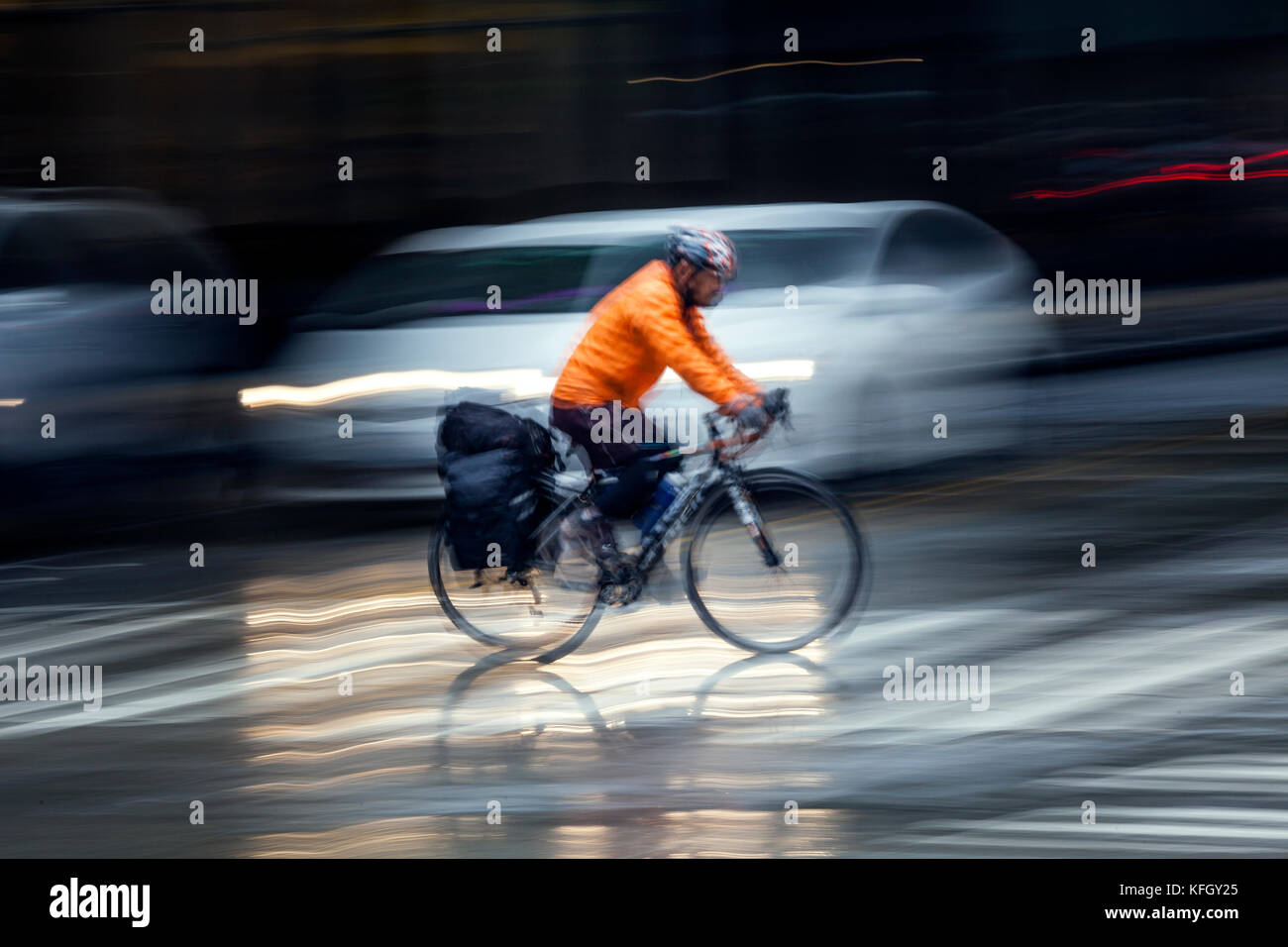 WA14178-00...WASHINGTON - Bicycle rider on a wet day in down town Seattle. (No MR) Stock Photo