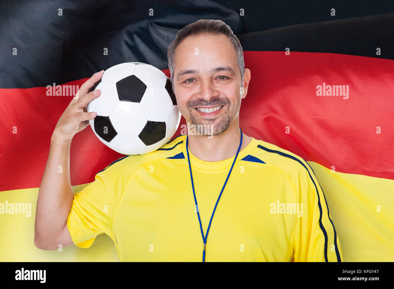 Happy German Soccer Referee With Football On Shoulder Stock Photo