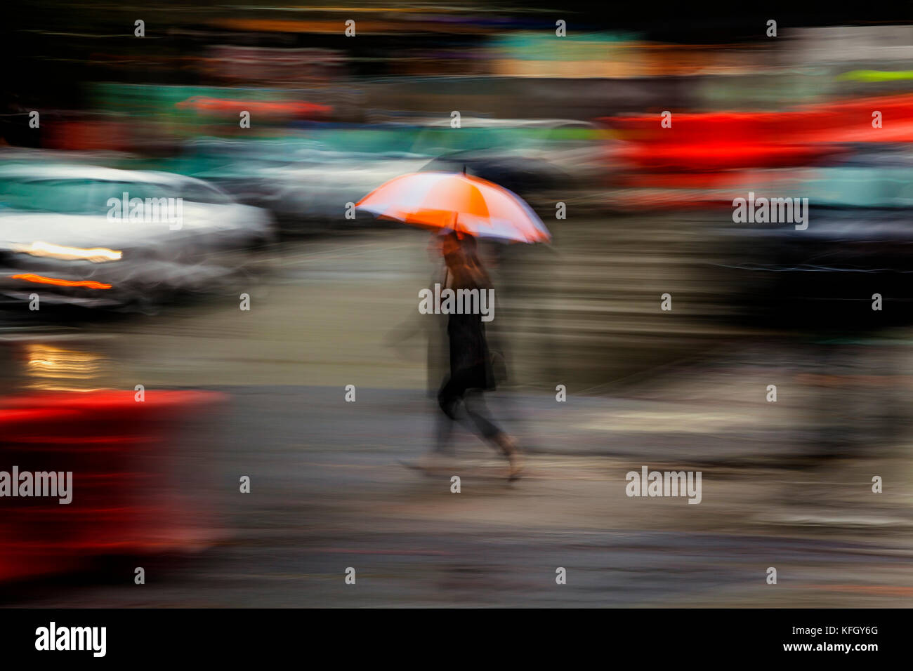 WA14194-00...WASHINGTON - Pedestrian with umbrella on a wet day in down ...