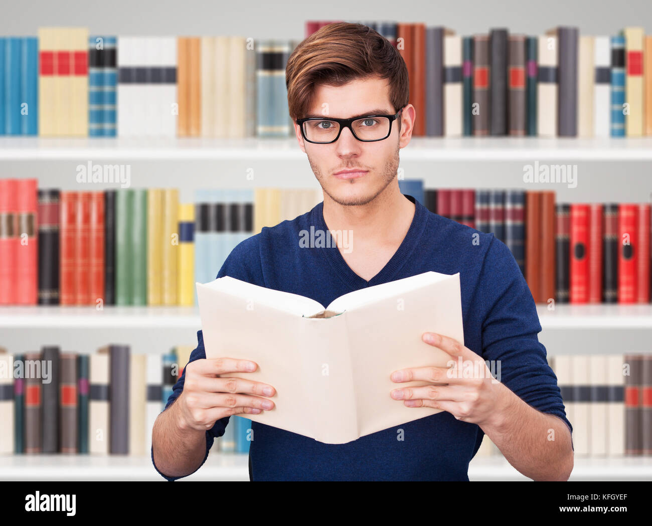 Portrait Of A Man Holding Book In Library Stock Photo