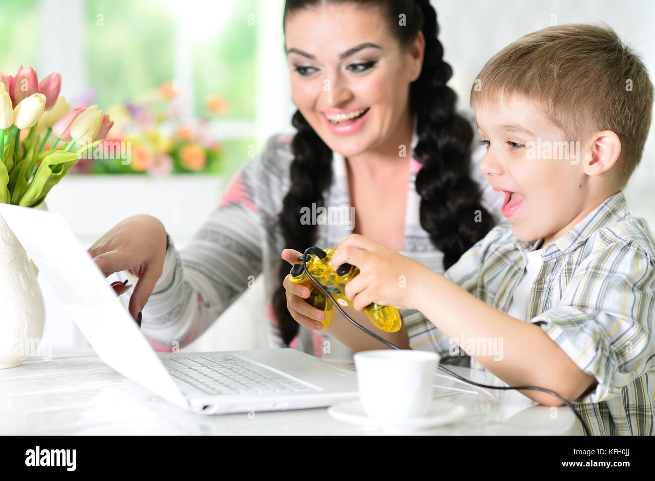 Mother and son playing computer game Stock Photo