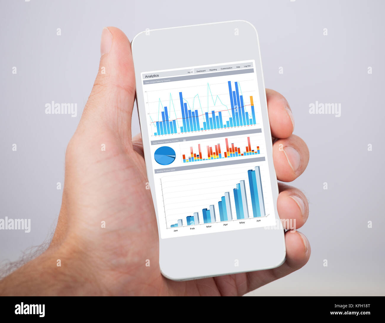 Closeup of man's hand holding mobile phone with financial charts Stock ...