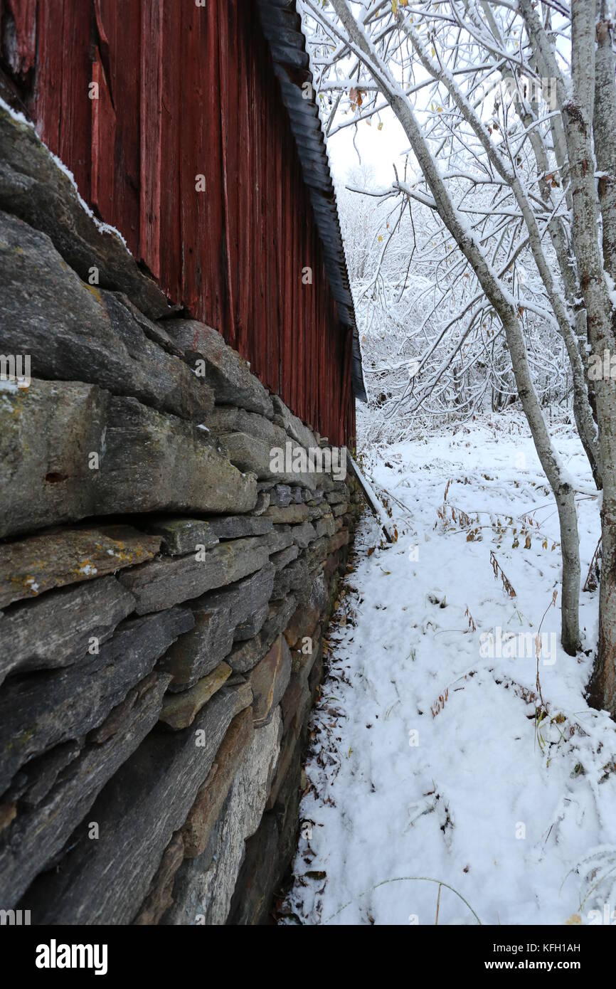 Red Barn Stone Foundation In Winter Forest Stock Photo