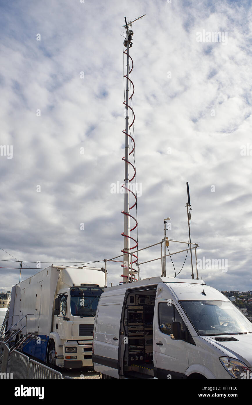 HD broadcasting vehicles with live video feed antennas on location. Stock Photo