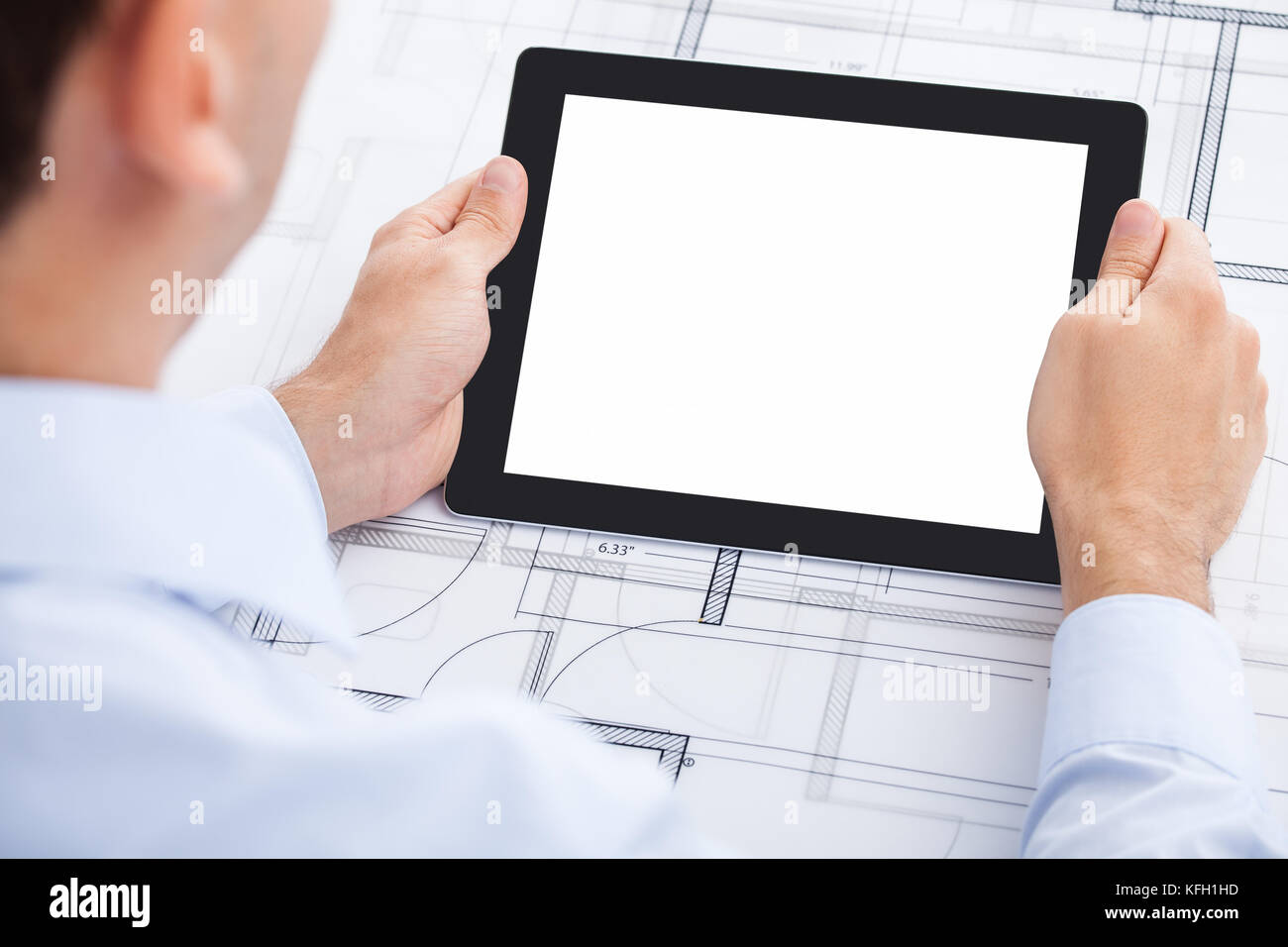 Cropped image of businessman holding blank digital tablet over ...