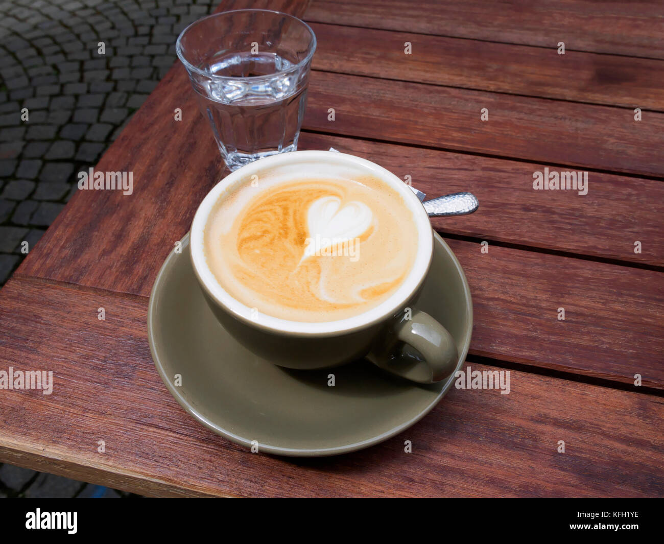 Cappuccino with a glass of water Stock Photo