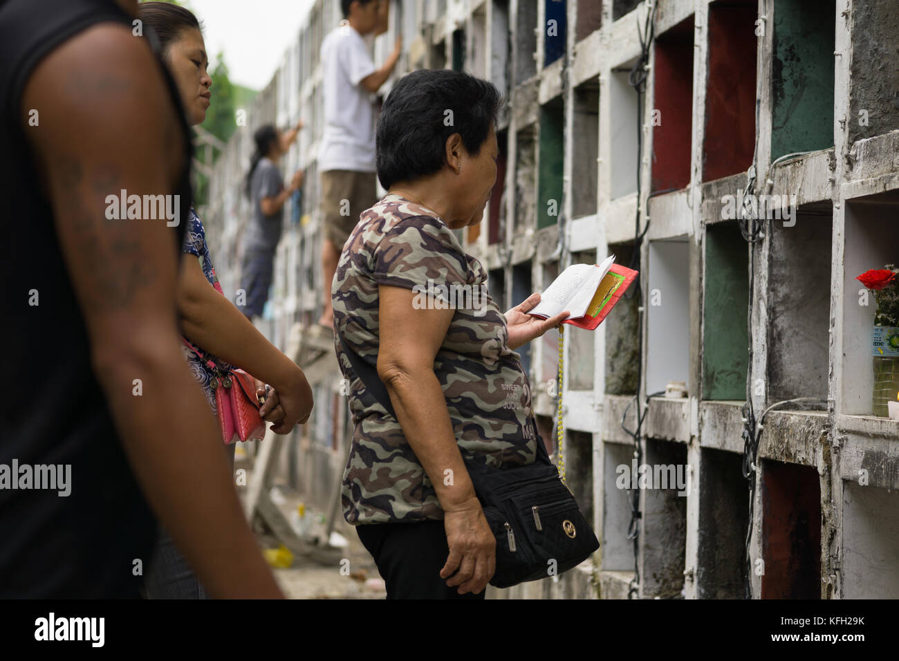 A Filipino family paying respect to deceased relatives prior to All Saints,All Souls day,Cebu City,Philippines Stock Photo