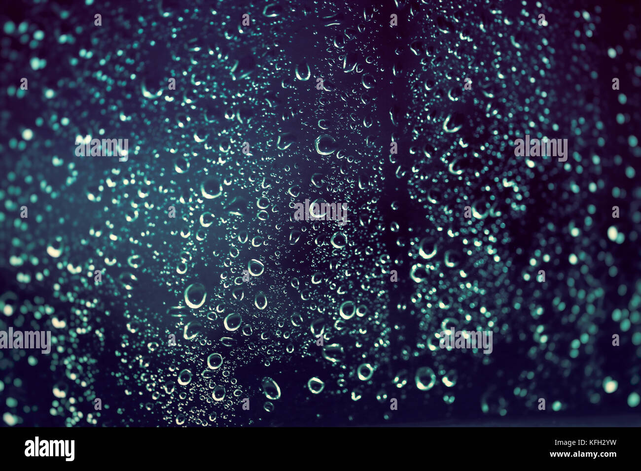 Rainy background, rain drops on the window at night, autumn season backdrop, abstract textured wallpaper Stock Photo