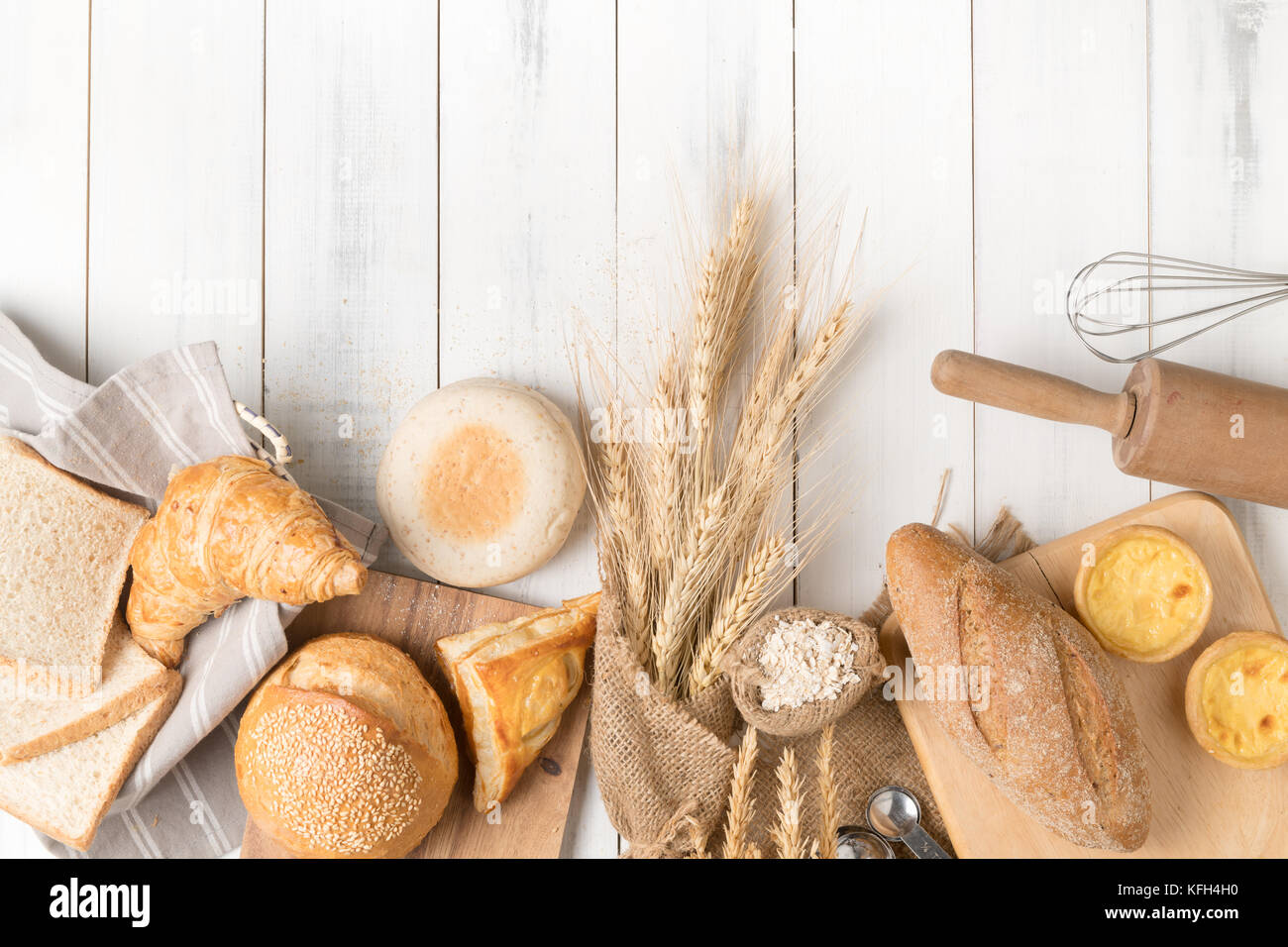 bread and bakery ingredients on white wooden background, top view and ...