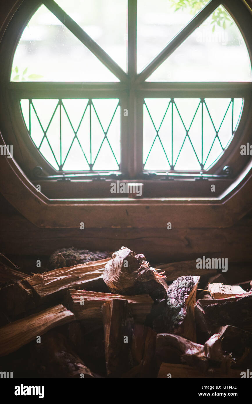 A pile of Firewood piled up by a window in Hobbiton, New Zealand Stock Photo