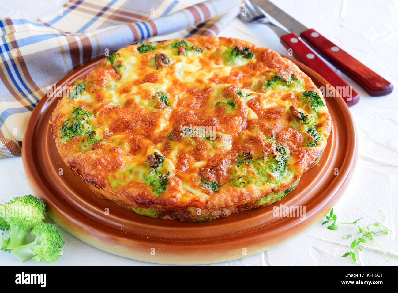 Broccoli pie on a brown ceramic plate. Healthy eating concept. Stock Photo