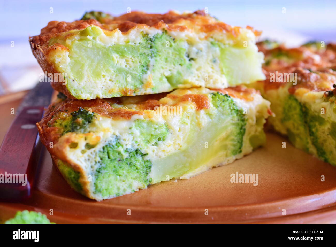 Broccoli pie on a brown ceramic plate. Healthy eating concept. Stock Photo