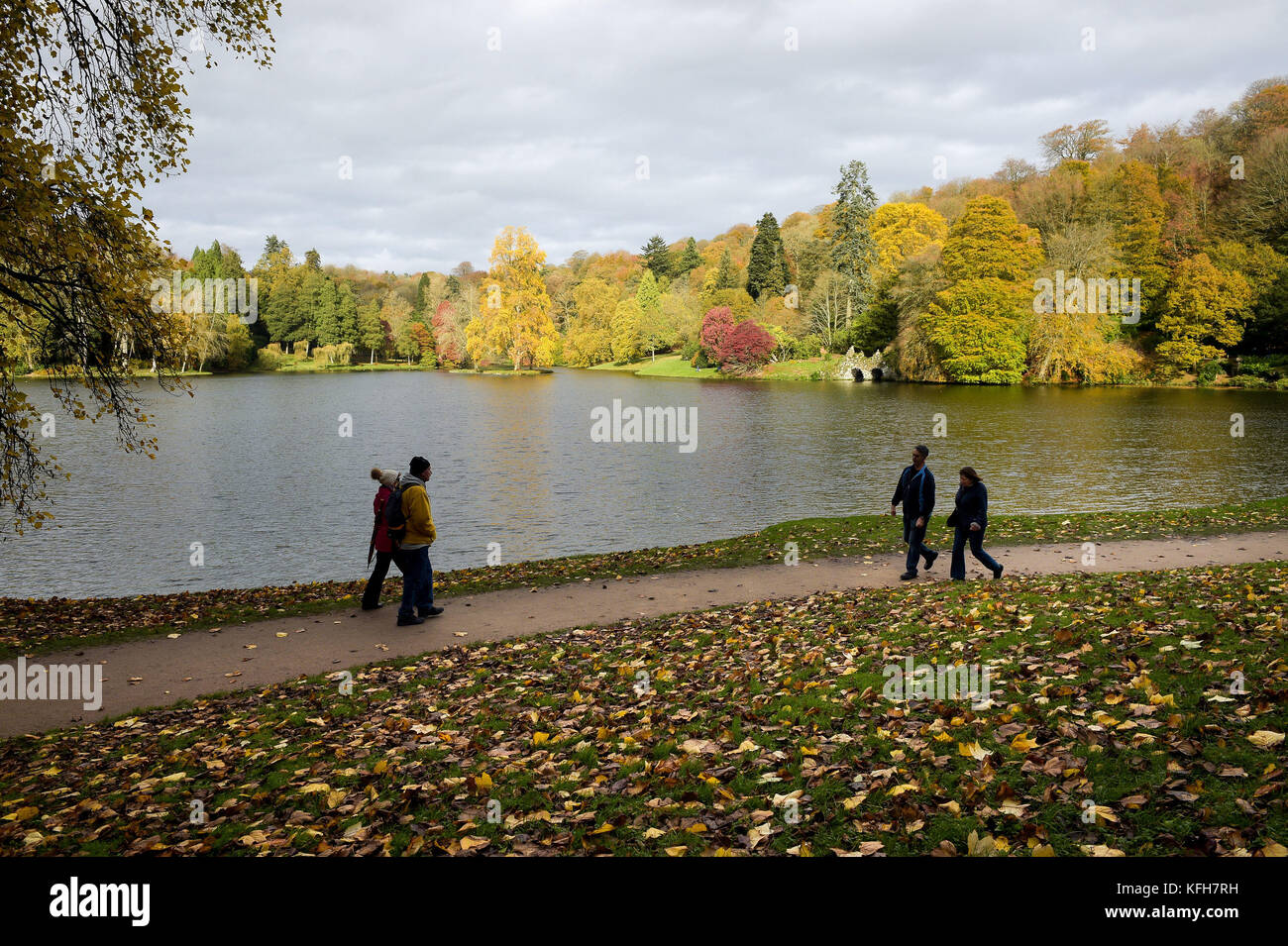 People enjoy the Autumn colours at The National Trust property Stourhead in Wiltshire. Stock Photo