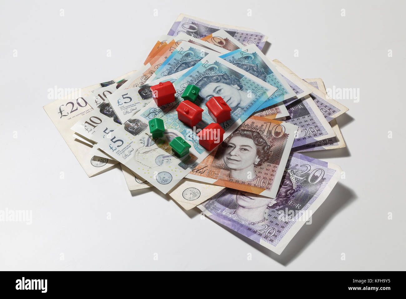 New British £5 and £10 notes with red and green monopoly houses and