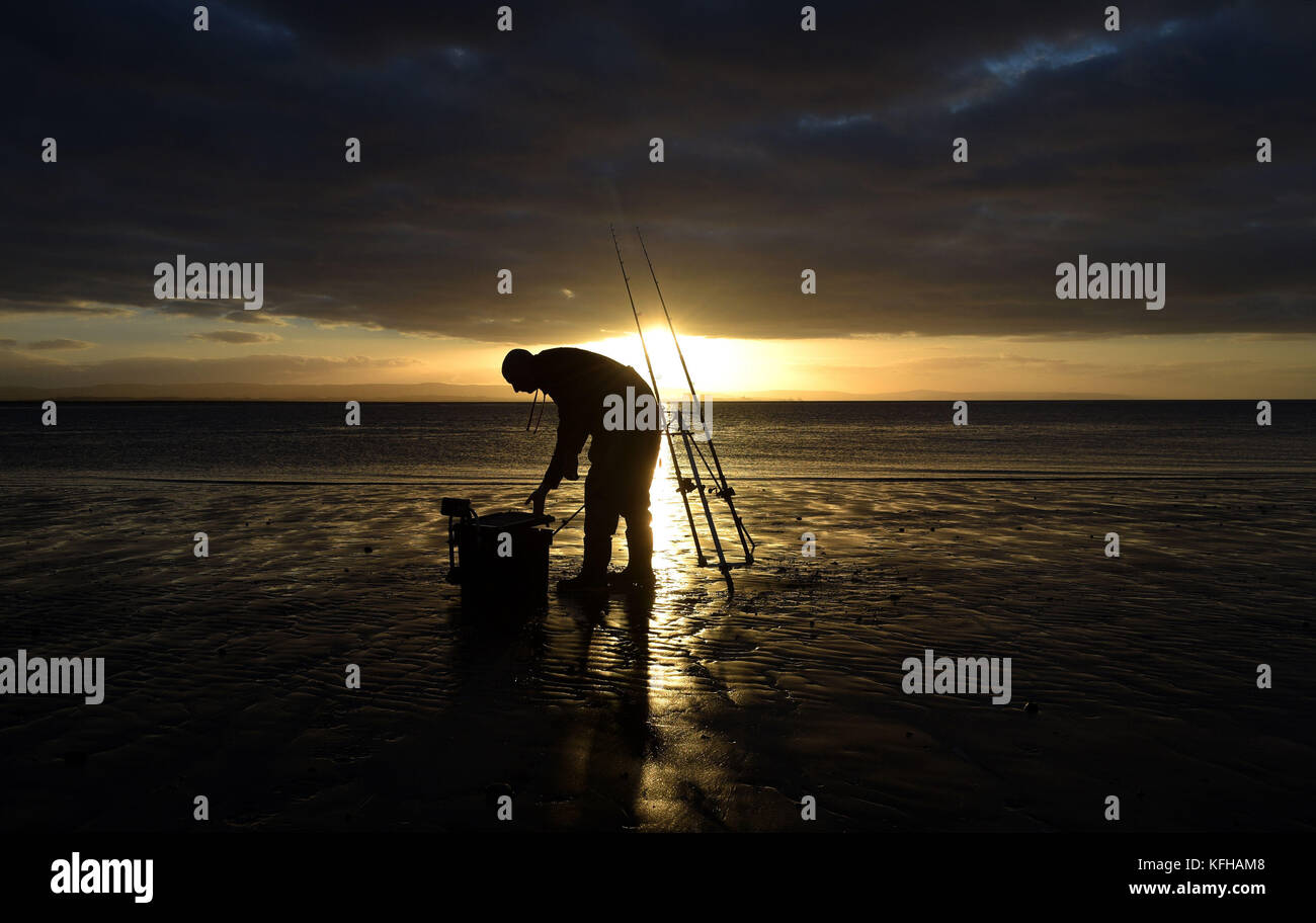 A lone angler on the beach at burnham on sea hi-res stock photography ...