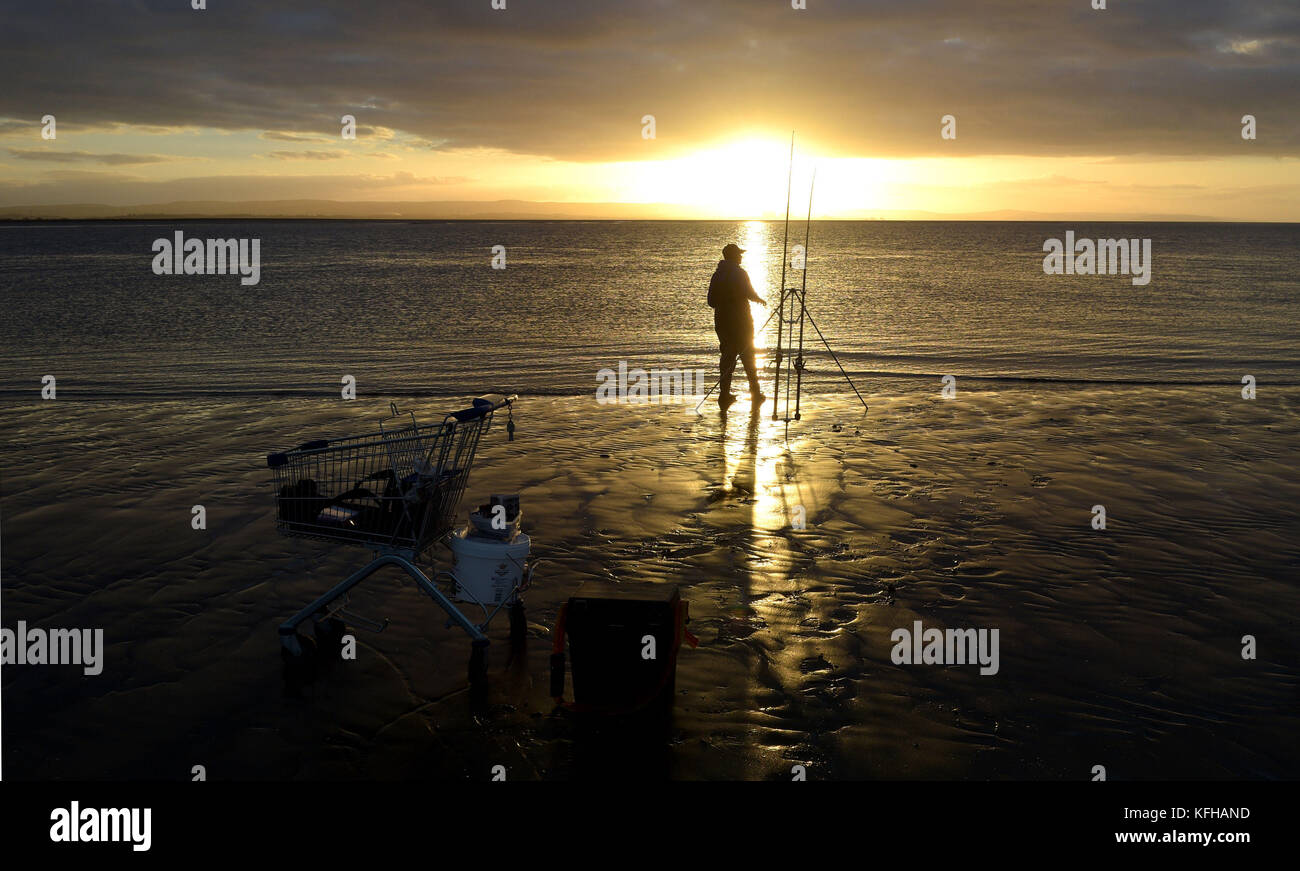 A lone angler on the beach at burnham on sea hi-res stock photography ...