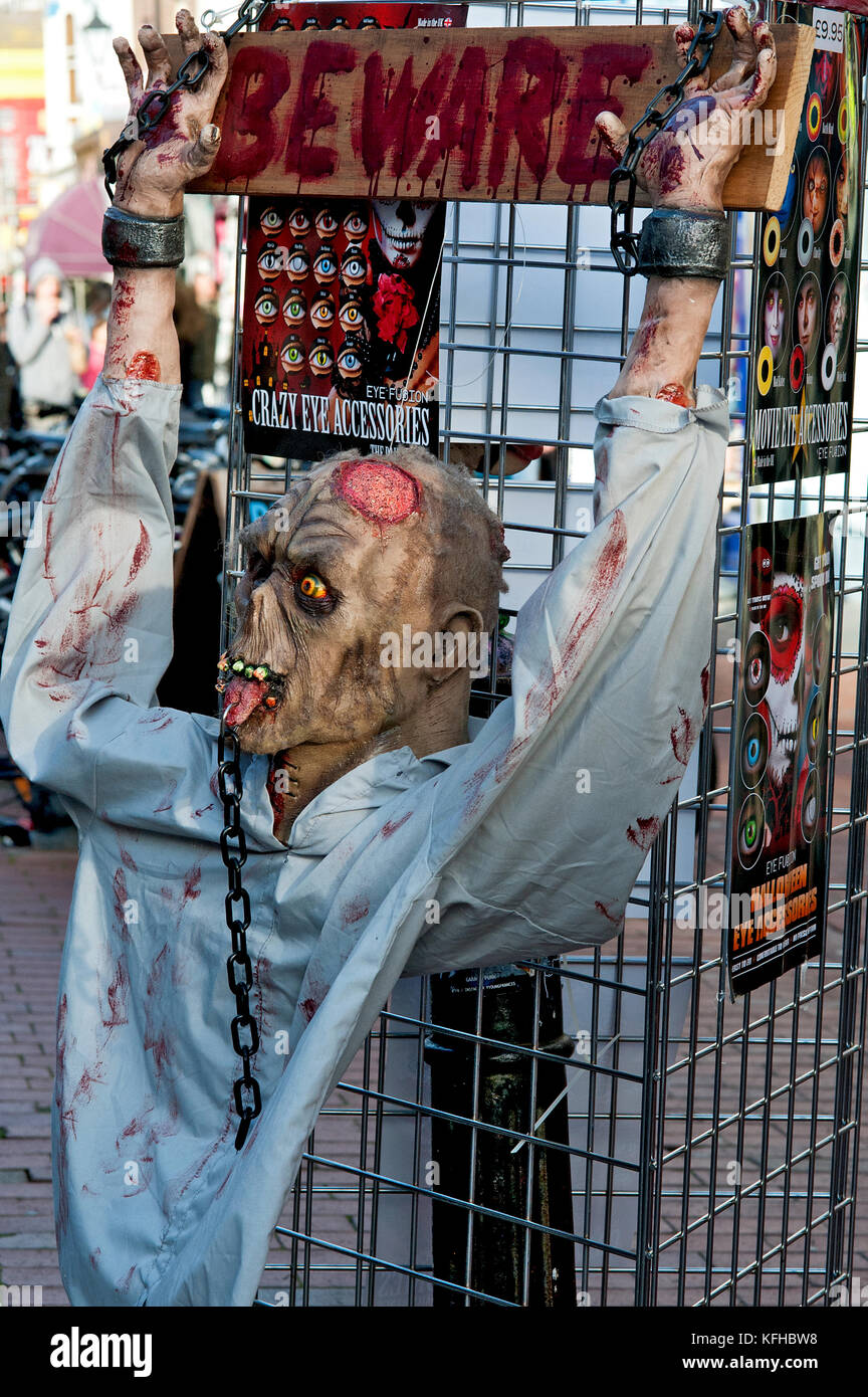 Zombie dummy chained outside a shop for Halloween in the North Laine shopping area of Brighton, England. Stock Photo