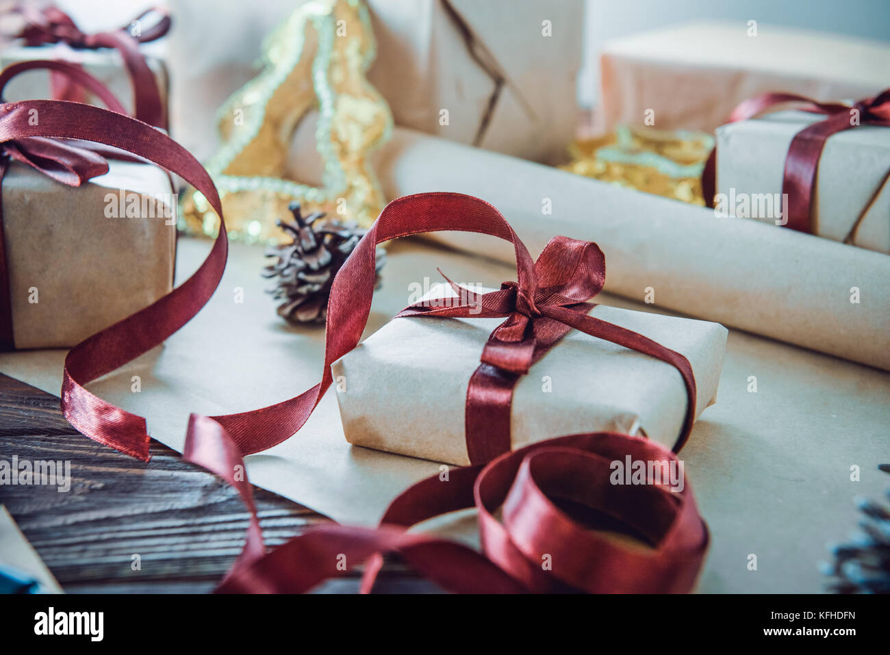 Close up christmas gift boxes in craft paper with satin ribbons and ...