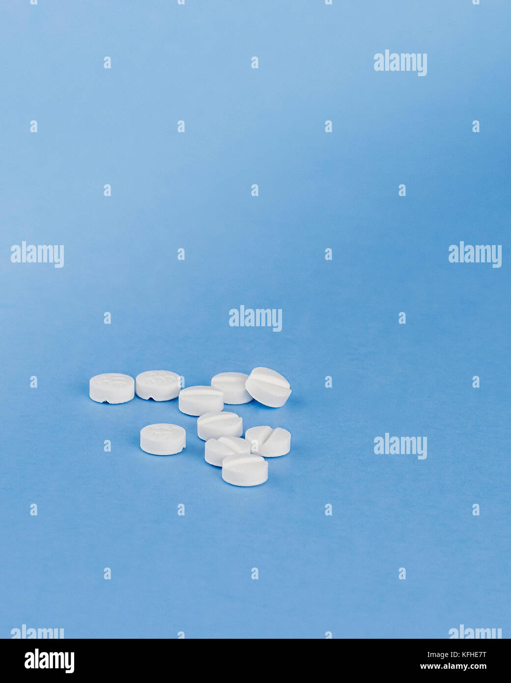 A group of 10 prescription prednisone pills used for treating allergies and inflammation on a blue background. USA Stock Photo