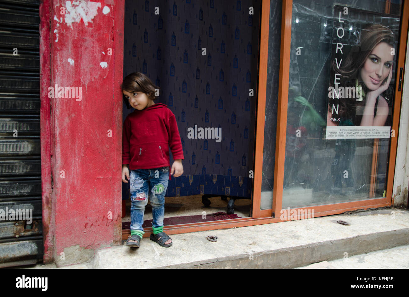 Beirut, Lebanon. 1st Mar, 2016. A young girl laying on the door of an