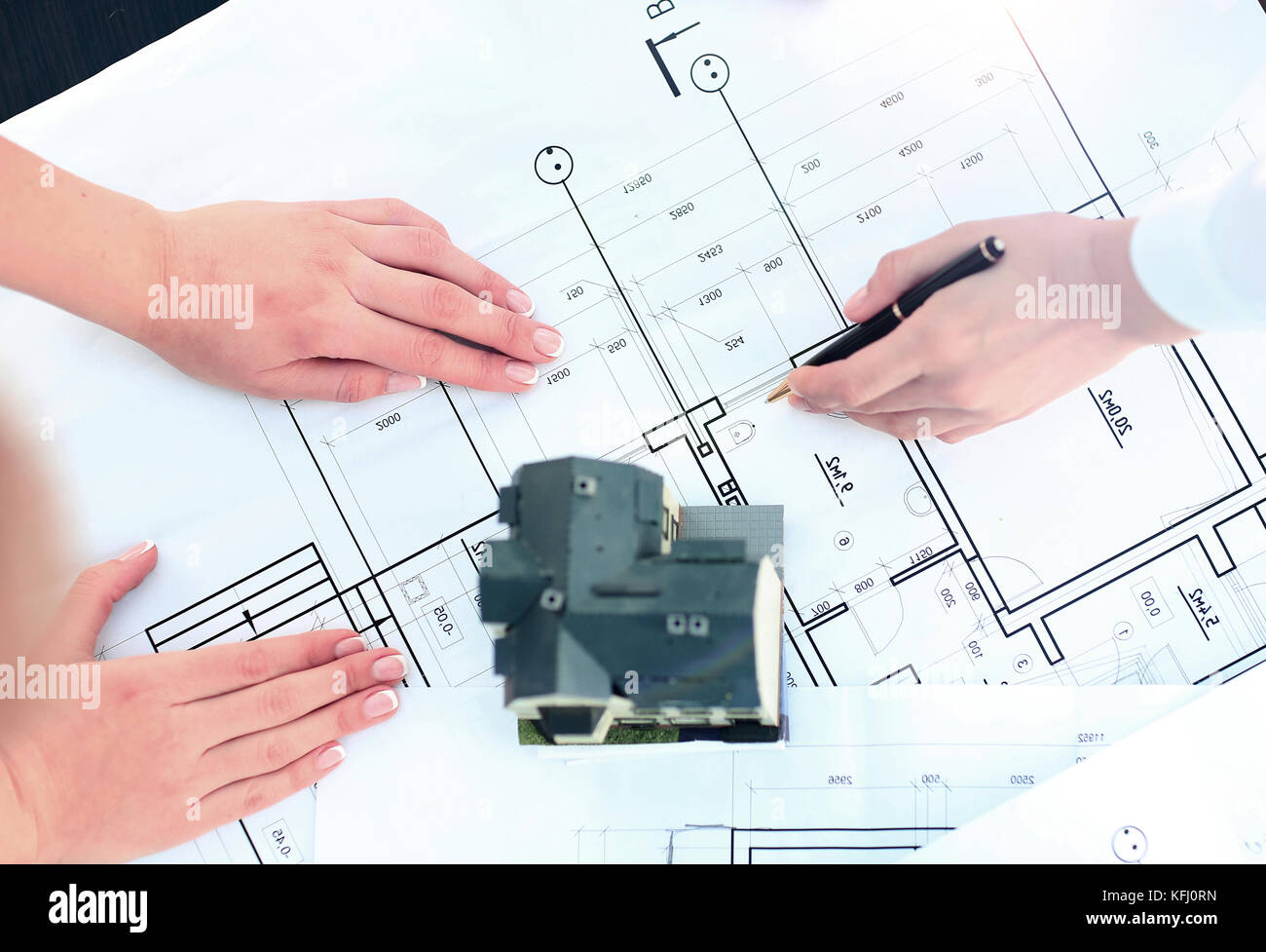 Image of new model house on architecture blueprint plan at desk Stock Photo