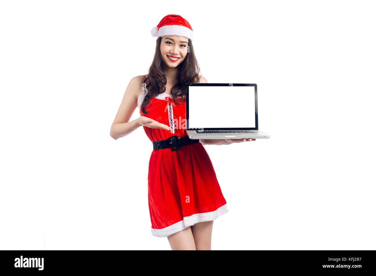 Asian Christmas girl with Santa Claus clothes holding laptop isolated ...