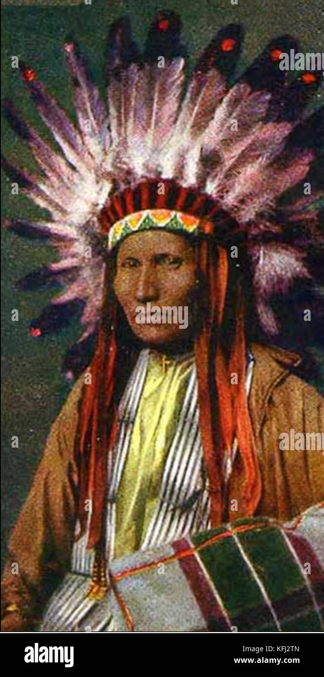 A Native American Indian Chief in full clothing complete with feather head-dress Stock Photo