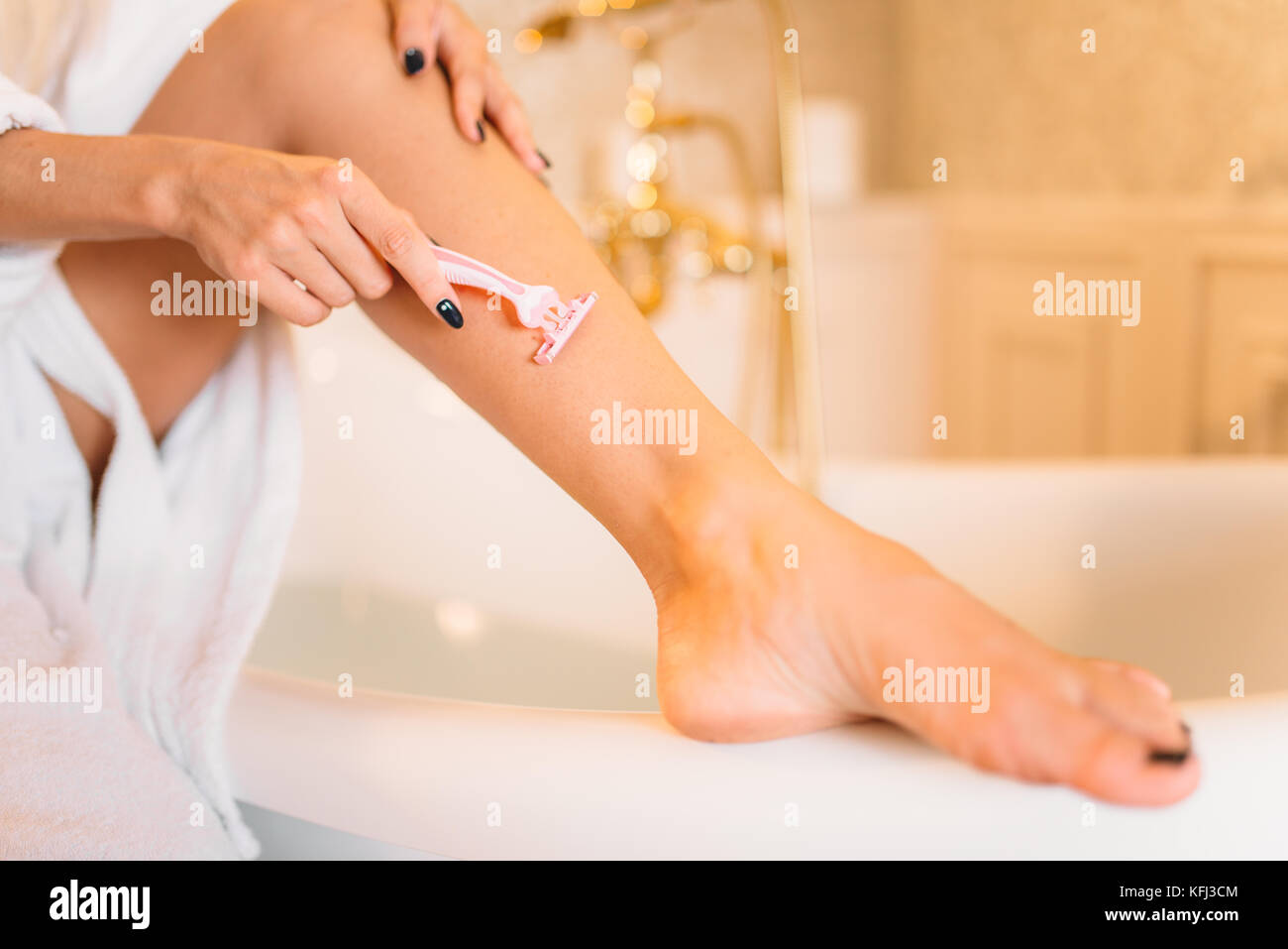 Female person shaves legs in bathroom, skincare. Bodycare and hygiene