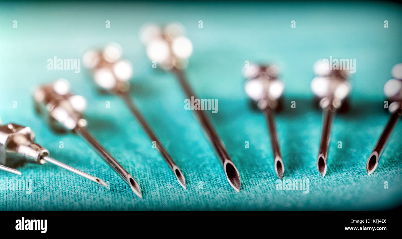 Set Of Metallic Needles Of Different Size Along With Syringe On Operations Table Stock Photo Alamy