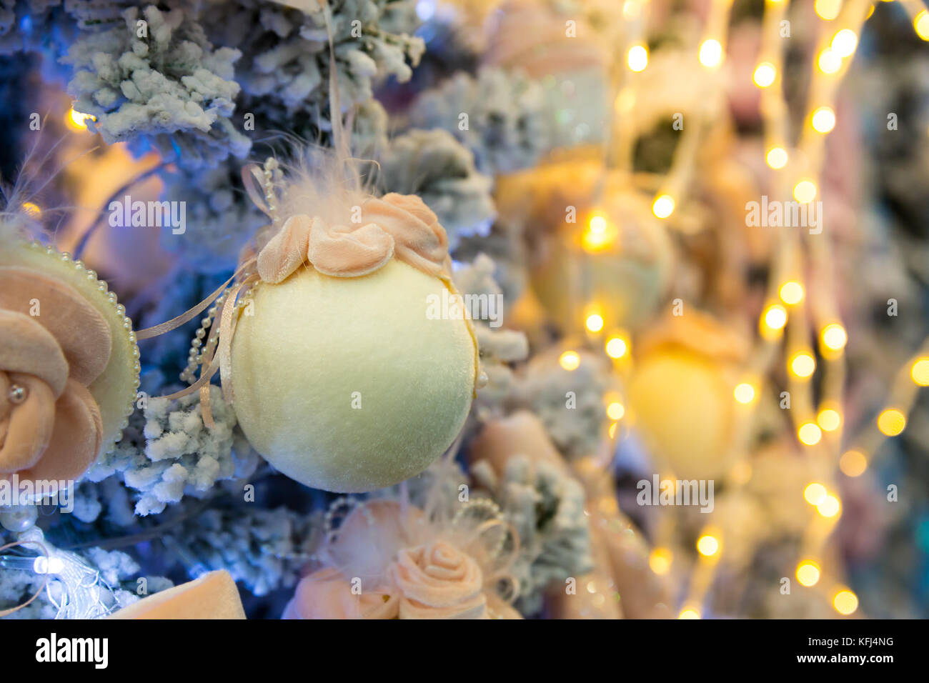 Christmas tree decorated with soft balls and lights, garland closeup ...