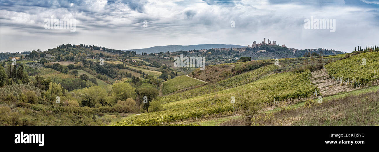 Beautiful hills with vineyards in Tuscany with UNESCO town San Gimignano in Italy Stock Photo