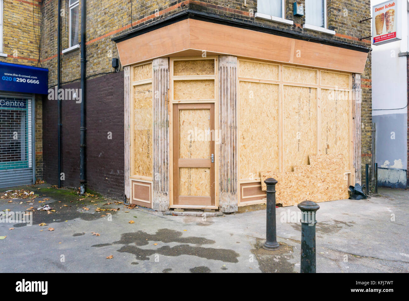 An empty shop boarded up before being re-fitted. Stock Photo