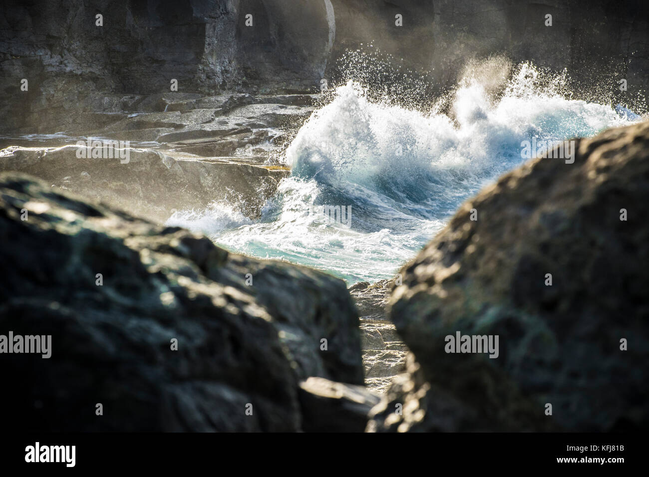 a close up view on ocean water that blur the rocks on Gran Canaria island Stock Photo