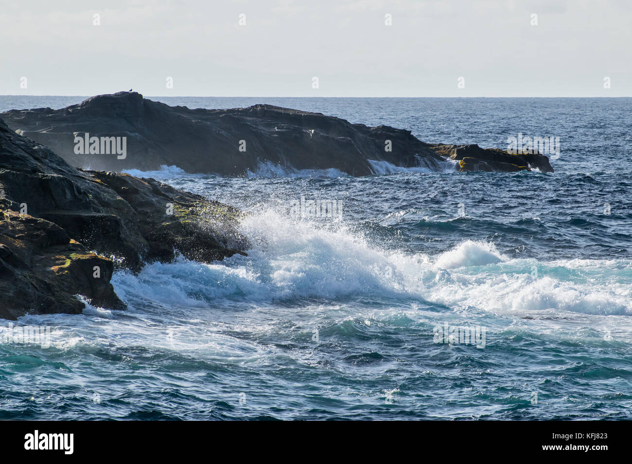 a close up view on ocean water that blur the rocks on Gran Canaria island Stock Photo