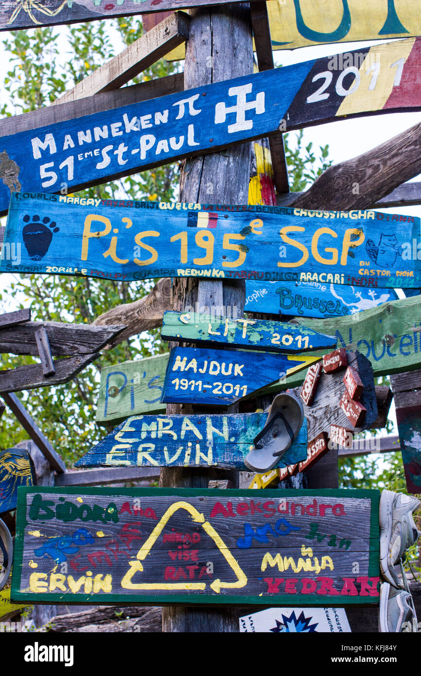 Signposts created by the volunteerse at the Kuterevo Bear Sanctuary, Lika, Croatia.   These signes are affixed to one of many totem poles at the site. Stock Photo