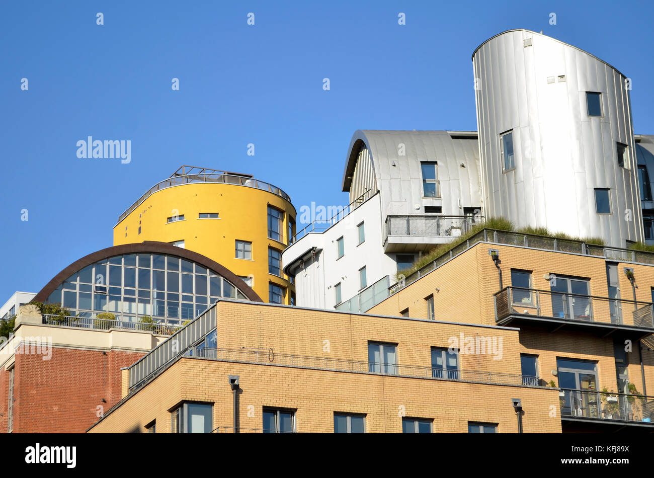 Aluminium cladding on buildings, Castle Yard seen from Hopton Street, London, SE1, UK. Yellow tower of 43 Holland Street behind. Stock Photo