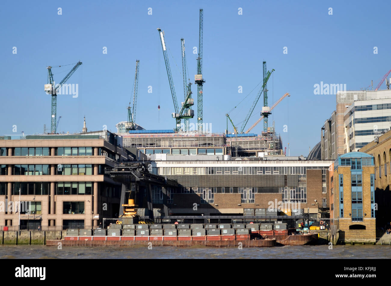 Cory Environmental waste management container site and barges at Walbrook Wharf, Upper Thames Street, London. Bloomberg Place cranes behind. Stock Photo