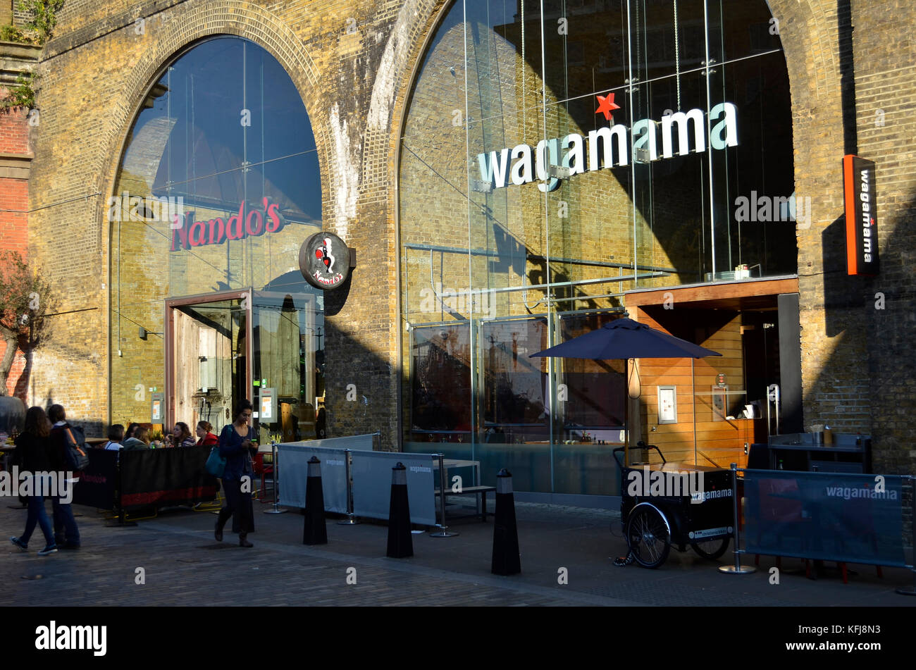 Nando's and Wagamama restaurants, Clink Street railway arches, London, UK. Stock Photo
