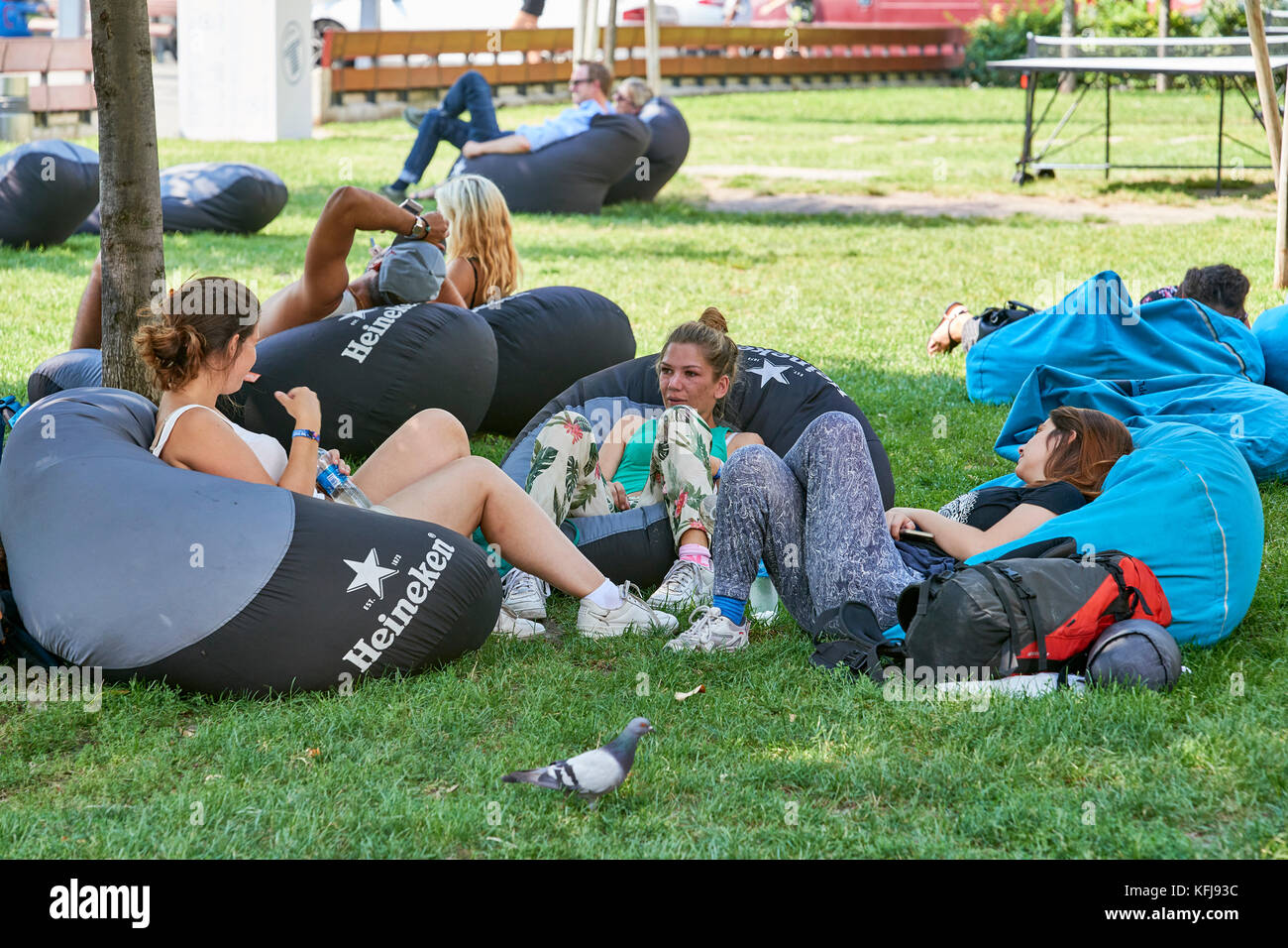 Young people relaxing on bean bags in public park (outdoors) Budapest Stock Photo