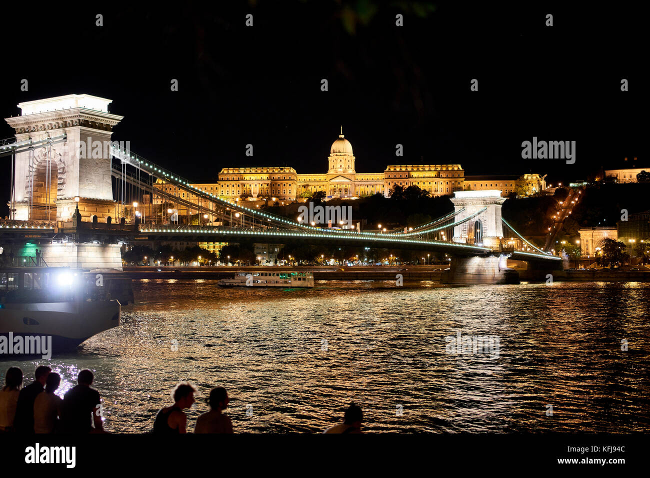 View of Buda castle Budapest with the chain link bridge Széchanyi Lánchid and river Danube in the foreground; taken at night Stock Photo