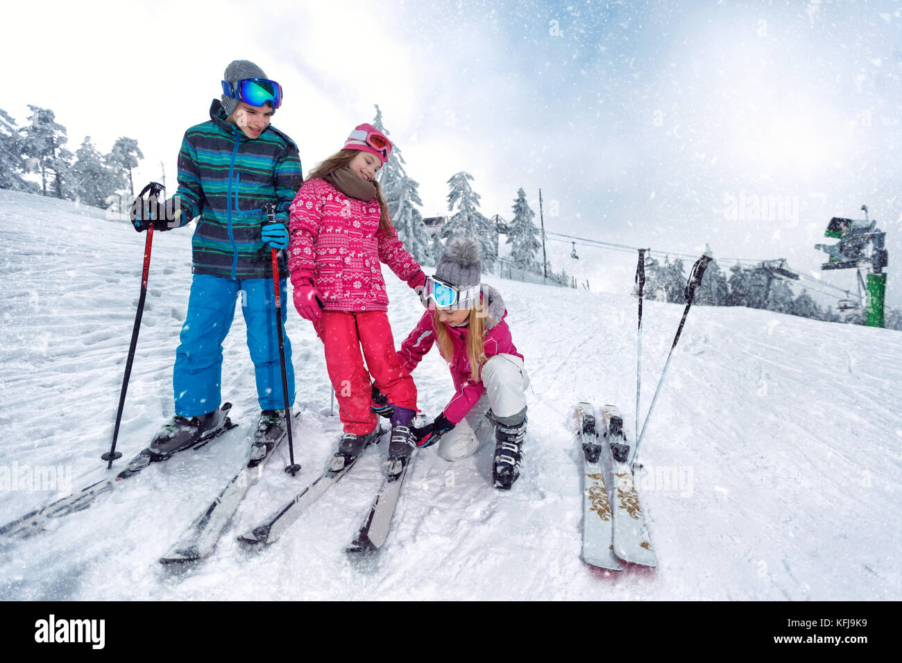 Skiing, winter fun-Mother preparing for skiing happy kids Stock Photo