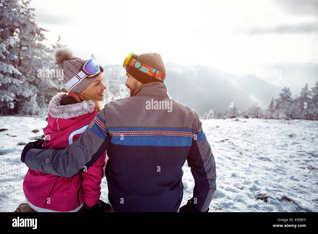 young couple in love enjoying on winter vacation together on the mountain Stock Photo