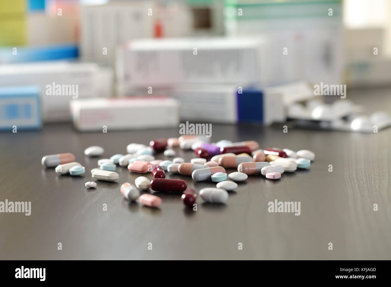 Close up of a lot of pills and medicines on a black wooden table Stock Photo