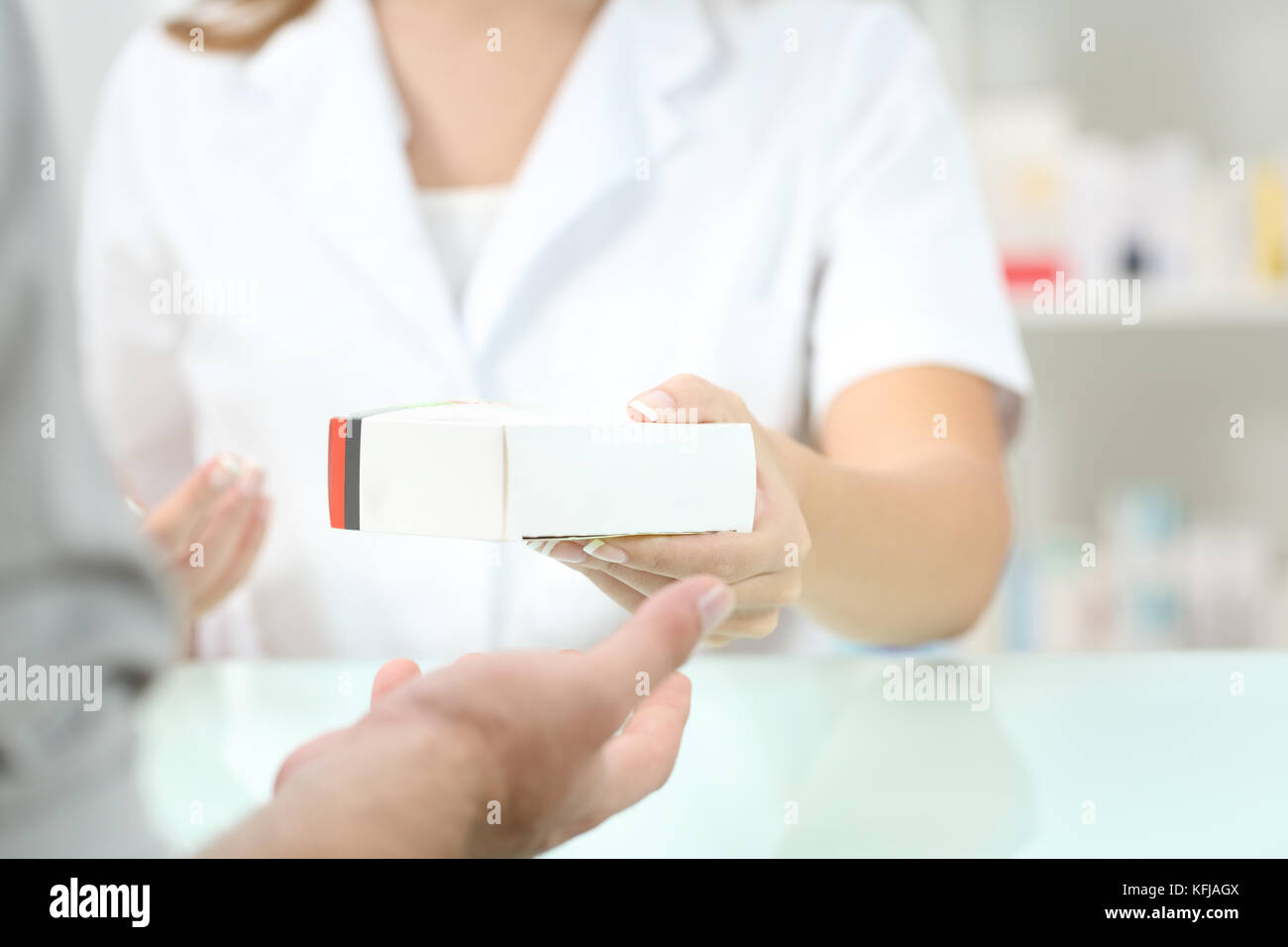 Close up of a pharmacist hand giving a medicament to a customer Stock Photo