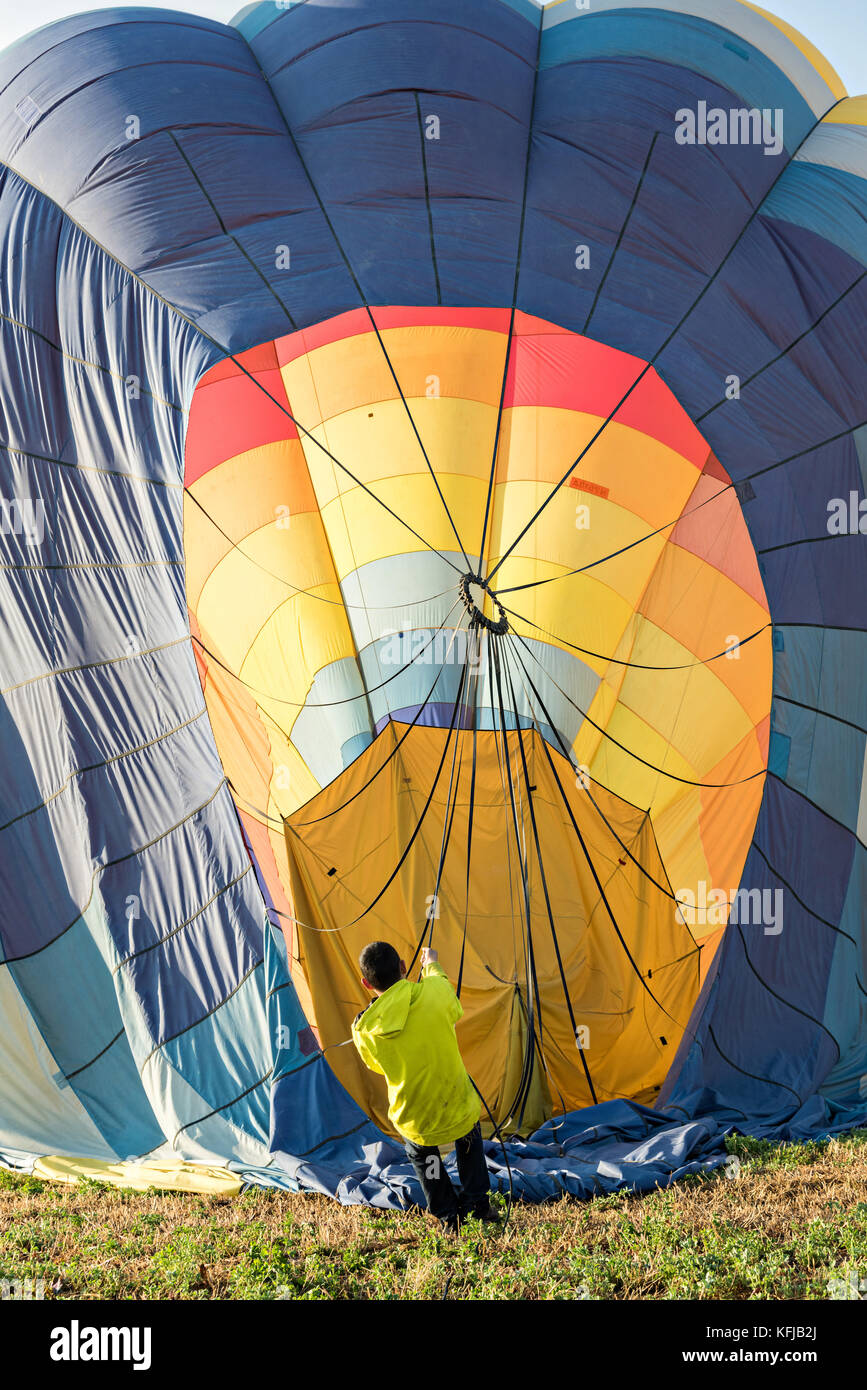 Ground crew begin deflating and securing a hot air balloon after