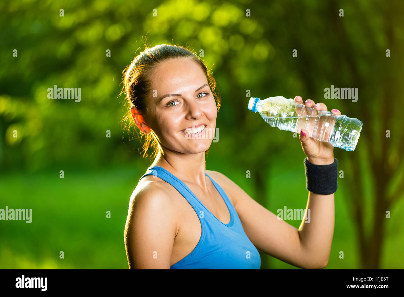 Young woman drinking water after fitness exercise Stock Photo