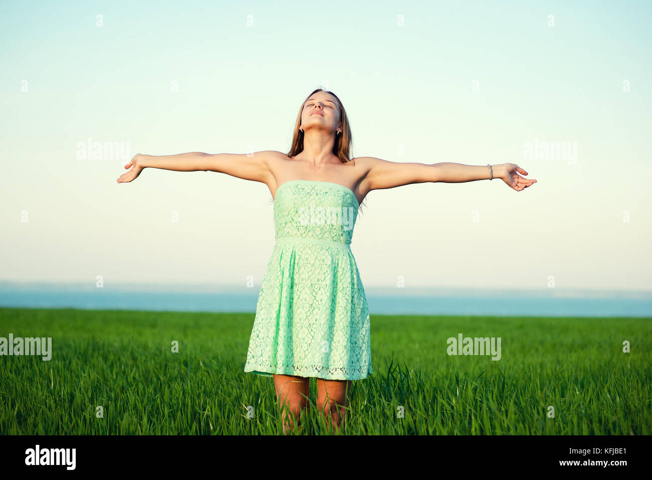 Happiness woman stay outdoor under sunlight of sunset Stock Photo